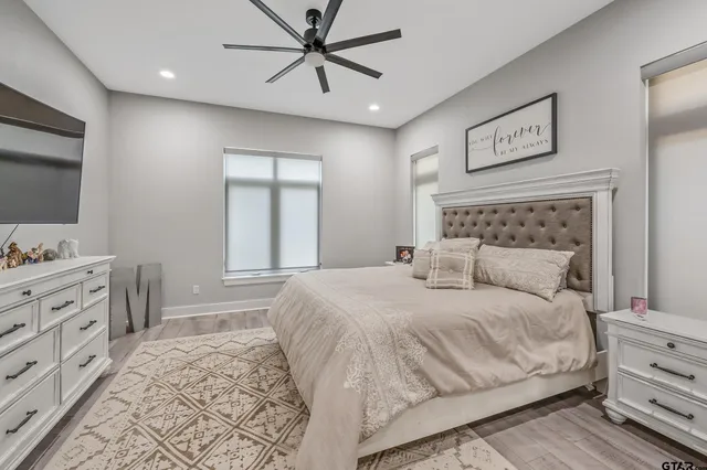 a bedroom with a large bed and a window