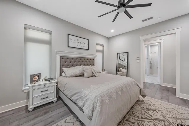 a bedroom with a bed and a ceiling fan