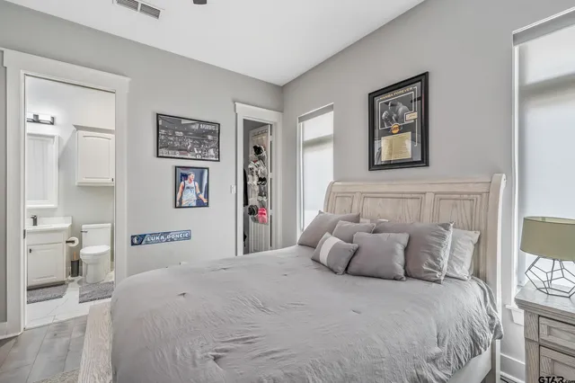 a bedroom with a large bed and a couch