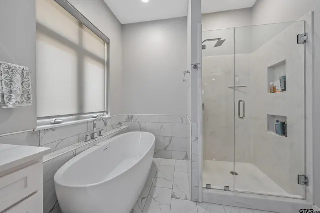 a bathroom with a bathtub and a shower