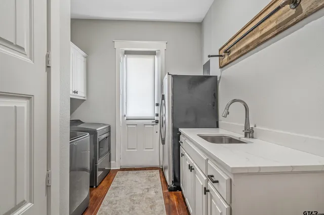 a kitchen with a sink and stainless steel appliances