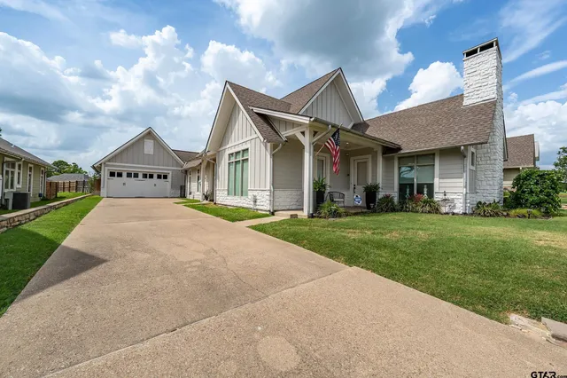 a view of a big house with a big yard and potted plants