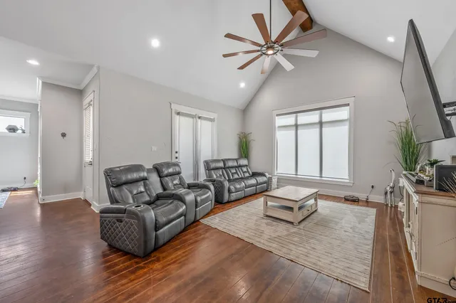 a living room with furniture and a wooden floor