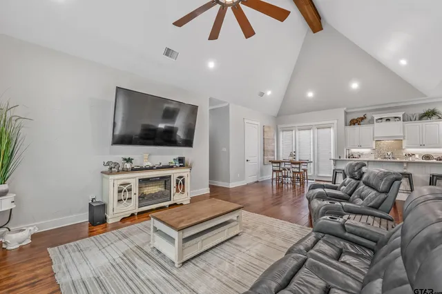 a living room with furniture and a flat screen tv
