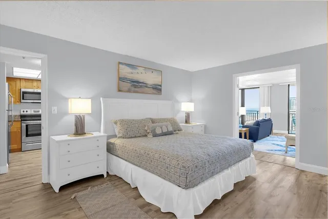 a bedroom with a bed and a night stand