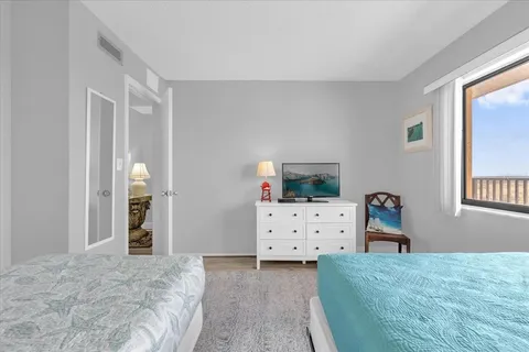 a bedroom with two beds and painted walls