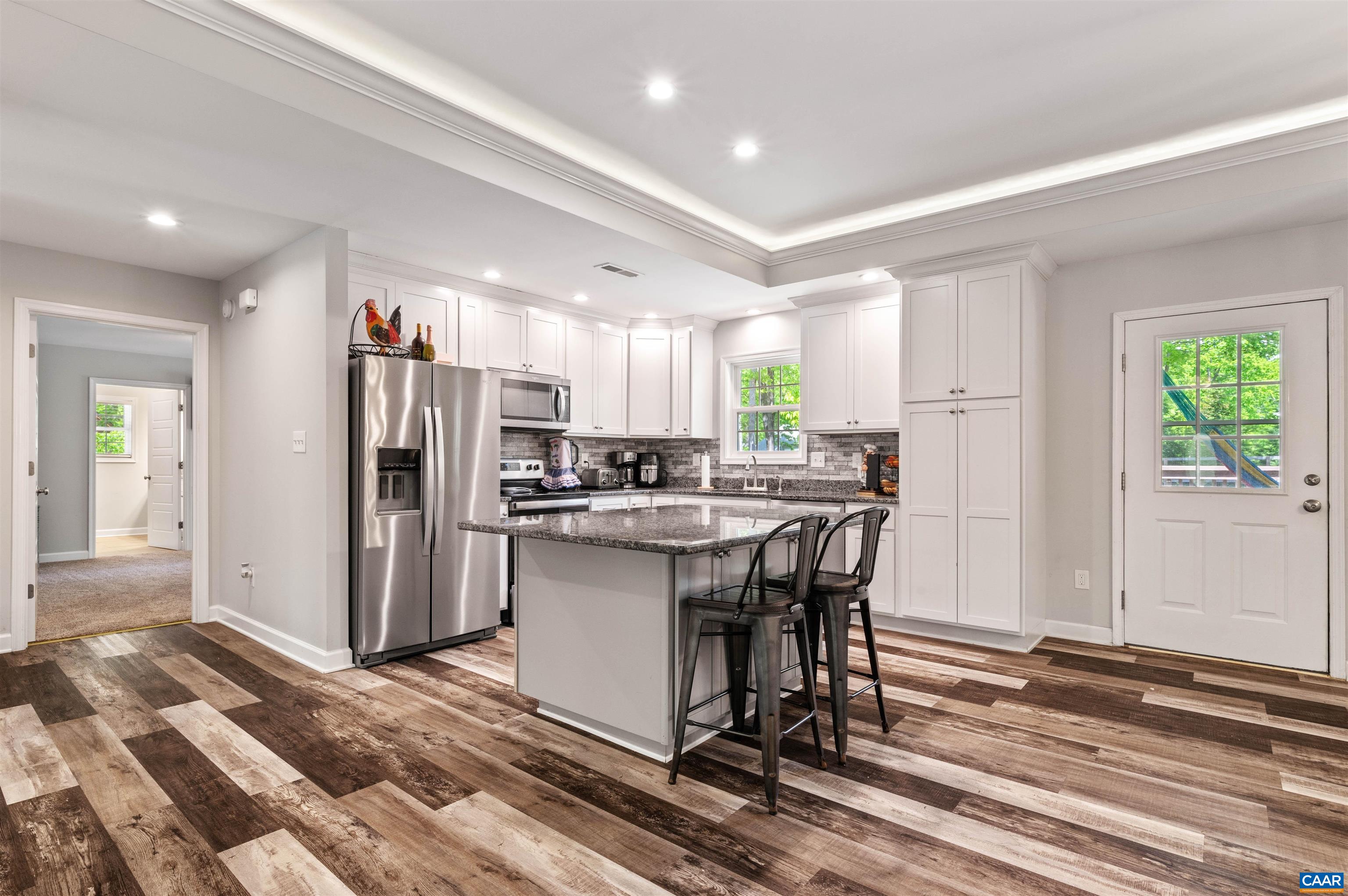 31 Oak Grove Road Palmyra, VA 22963 - Photo 8 of 28 a kitchen with stainless steel appliances kitchen island granite countertop a refrigerator and a sink