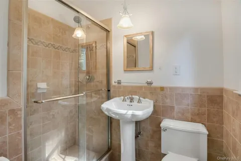 a bathroom with a sink toilet and shower