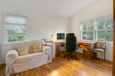 a living room with furniture and floor to ceiling window