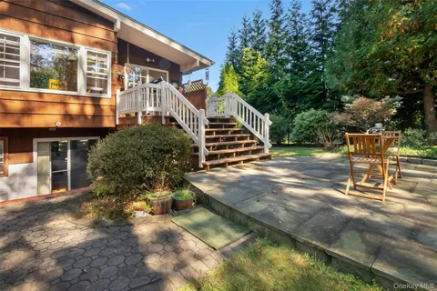 a view of a house with backyard and sitting area