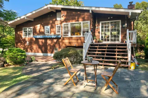 a view of a chair and table in backyard of the house