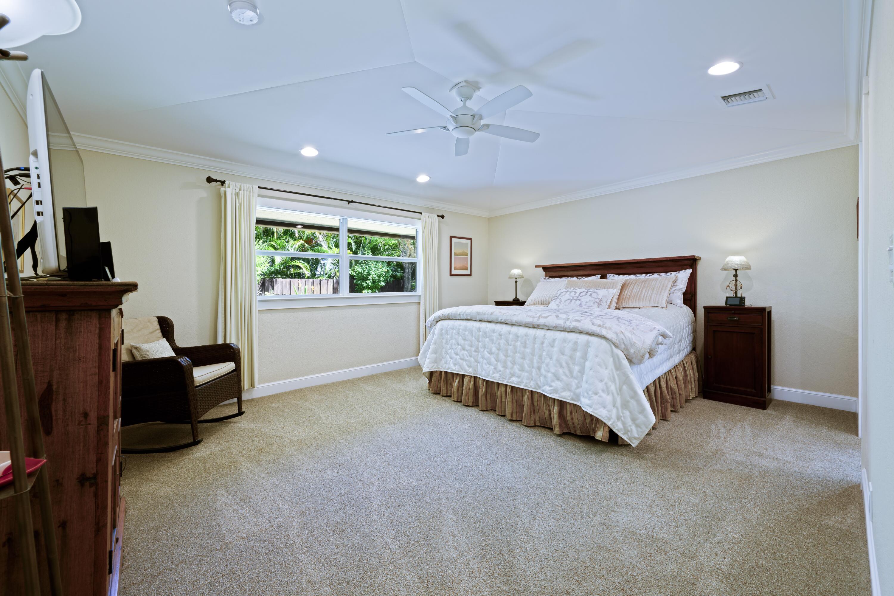 4535 Oak Tree Court Delray Beach, FL 33445 - Photo 20 of 43 a bedroom with a bed and a television
