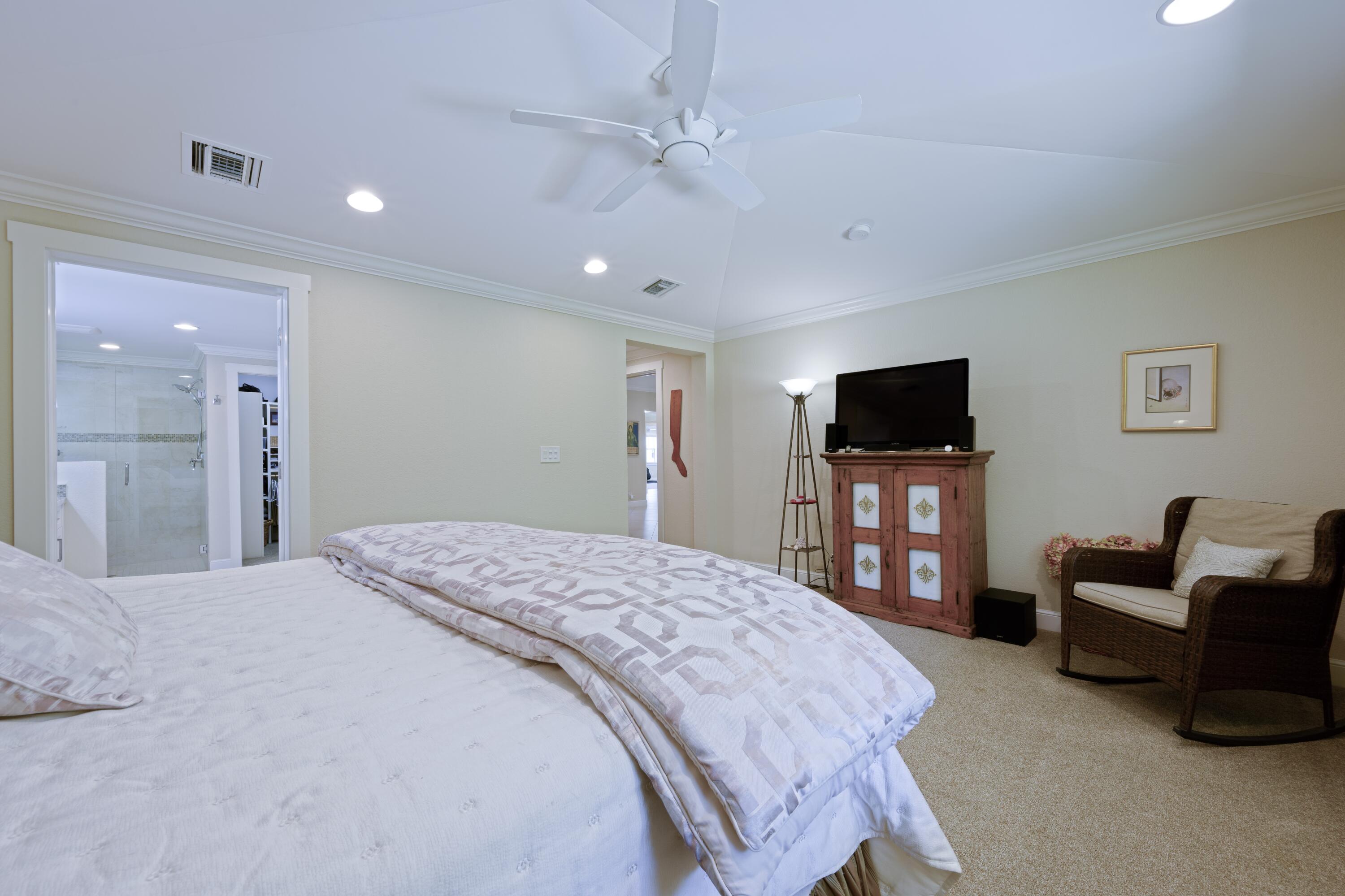 4535 Oak Tree Court Delray Beach, FL 33445 - Photo 21 of 43 a bedroom with a bed and a flat screen tv