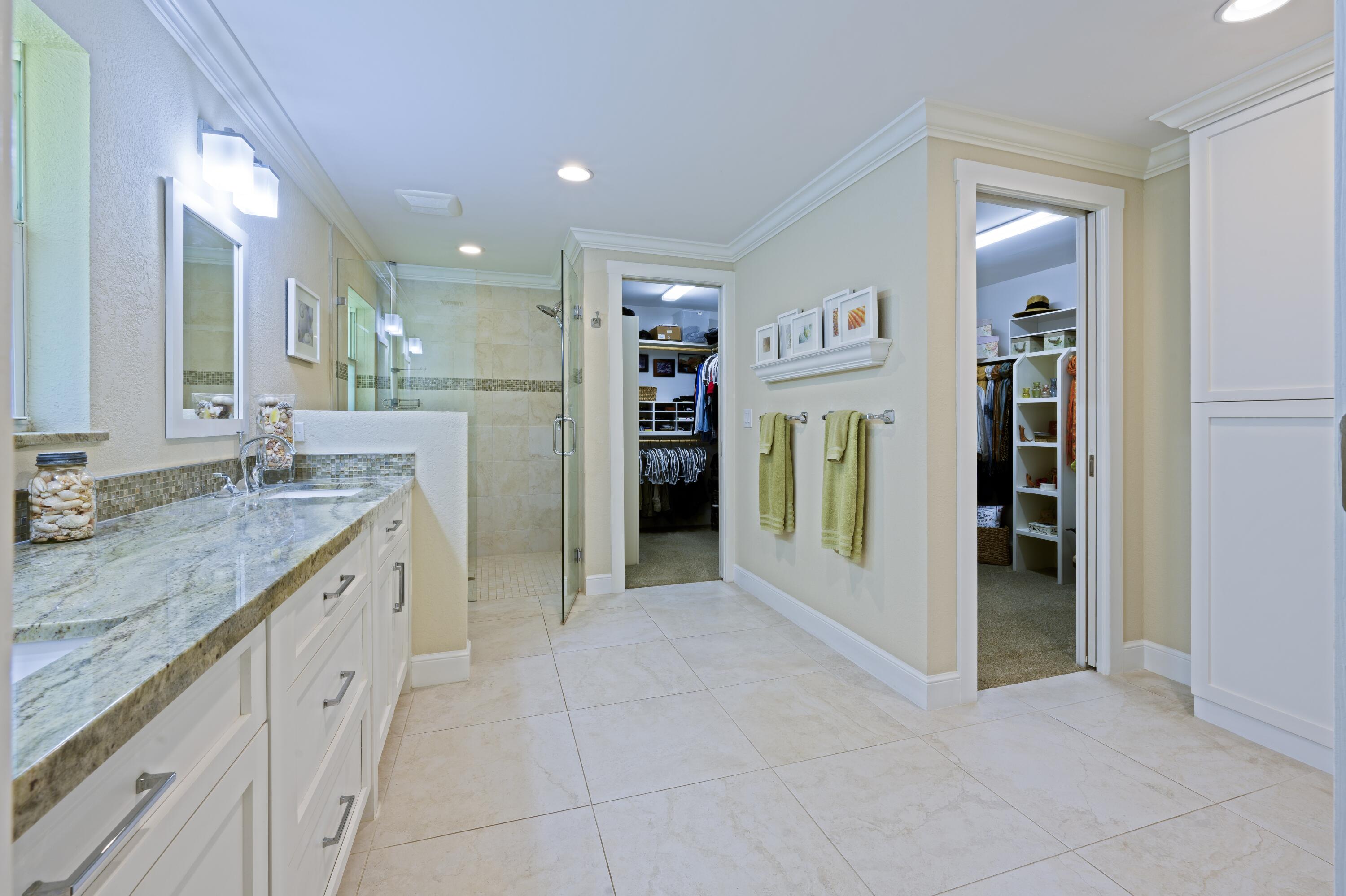4535 Oak Tree Court Delray Beach, FL 33445 - Photo 22 of 43 a spacious bathroom with a granite countertop sink and a mirror