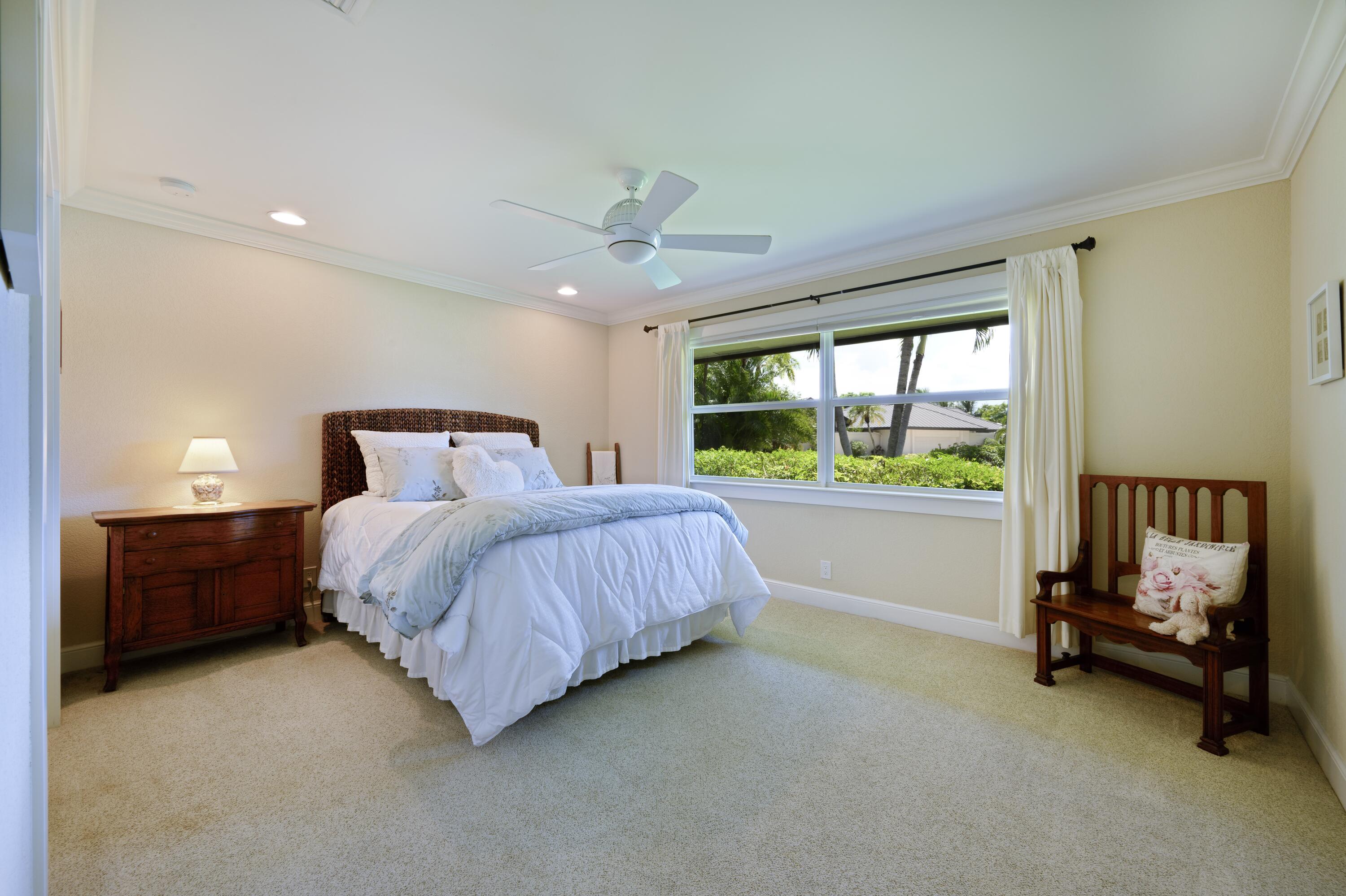 4535 Oak Tree Court Delray Beach, FL 33445 - Photo 25 of 43 a bedroom with a bed chair and window