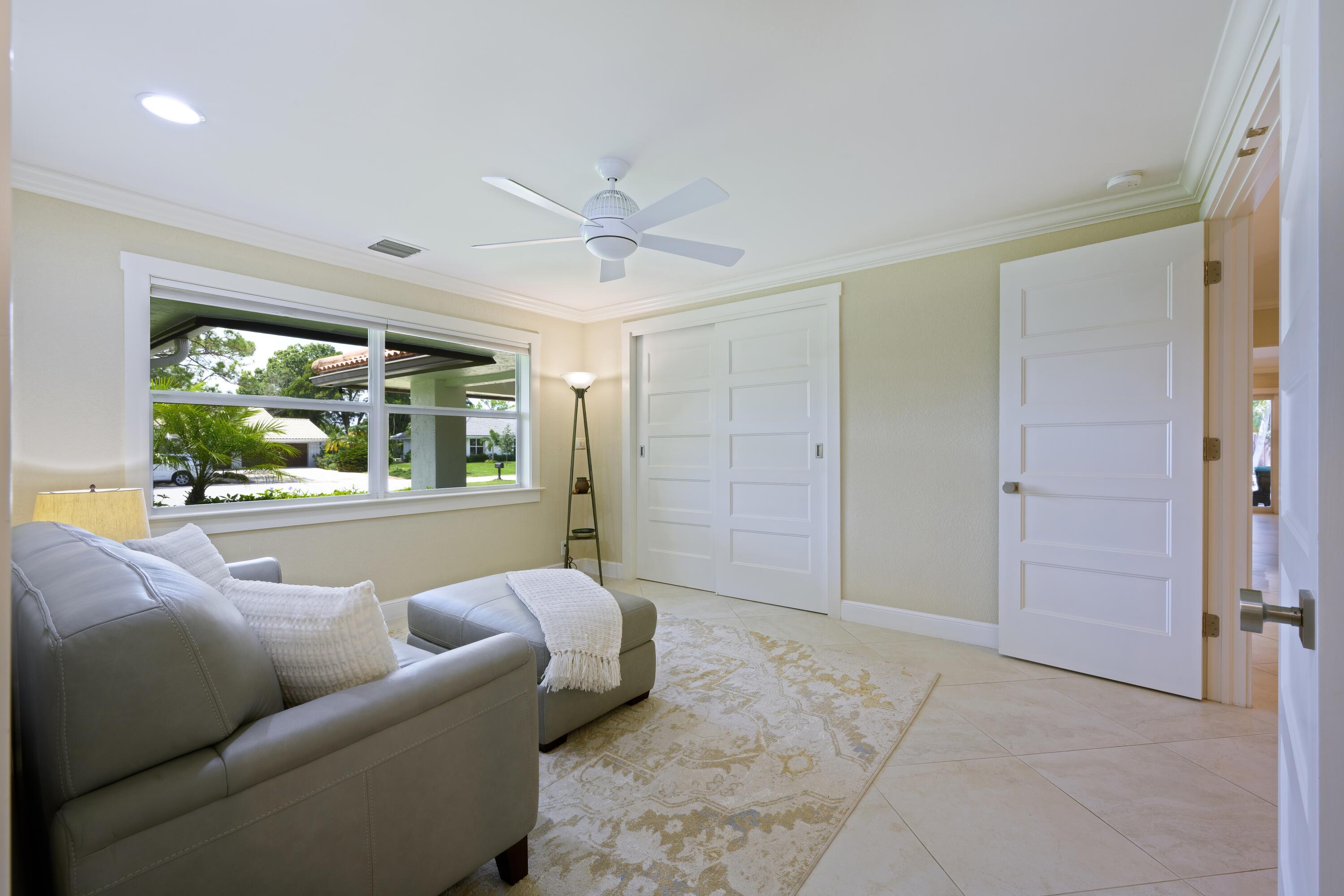 4535 Oak Tree Court Delray Beach, FL 33445 - Photo 26 of 43 a living room with furniture and a large window