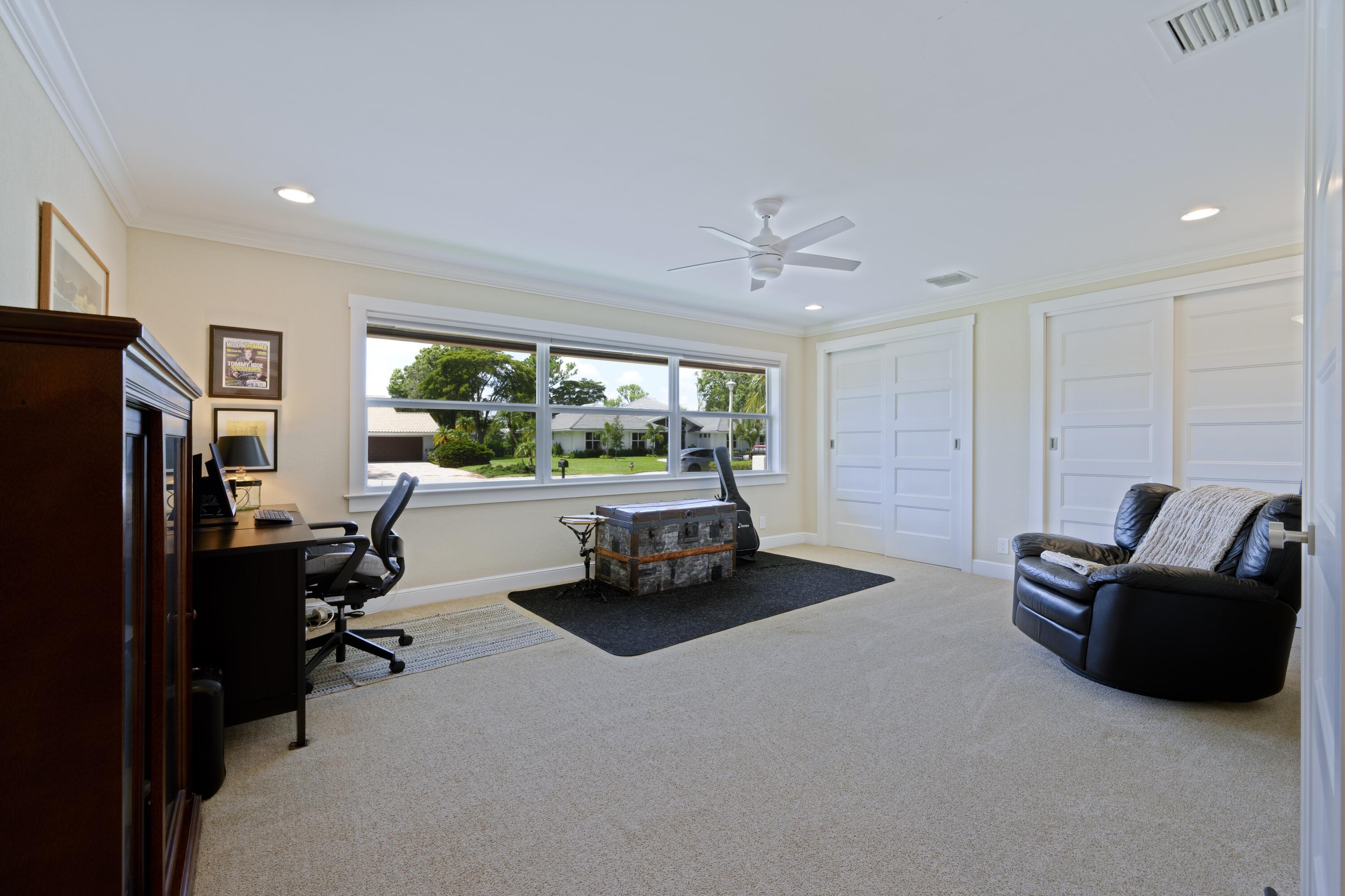 4535 Oak Tree Court Delray Beach, FL 33445 - Photo 27 of 43 a room with furniture and a flat screen tv
