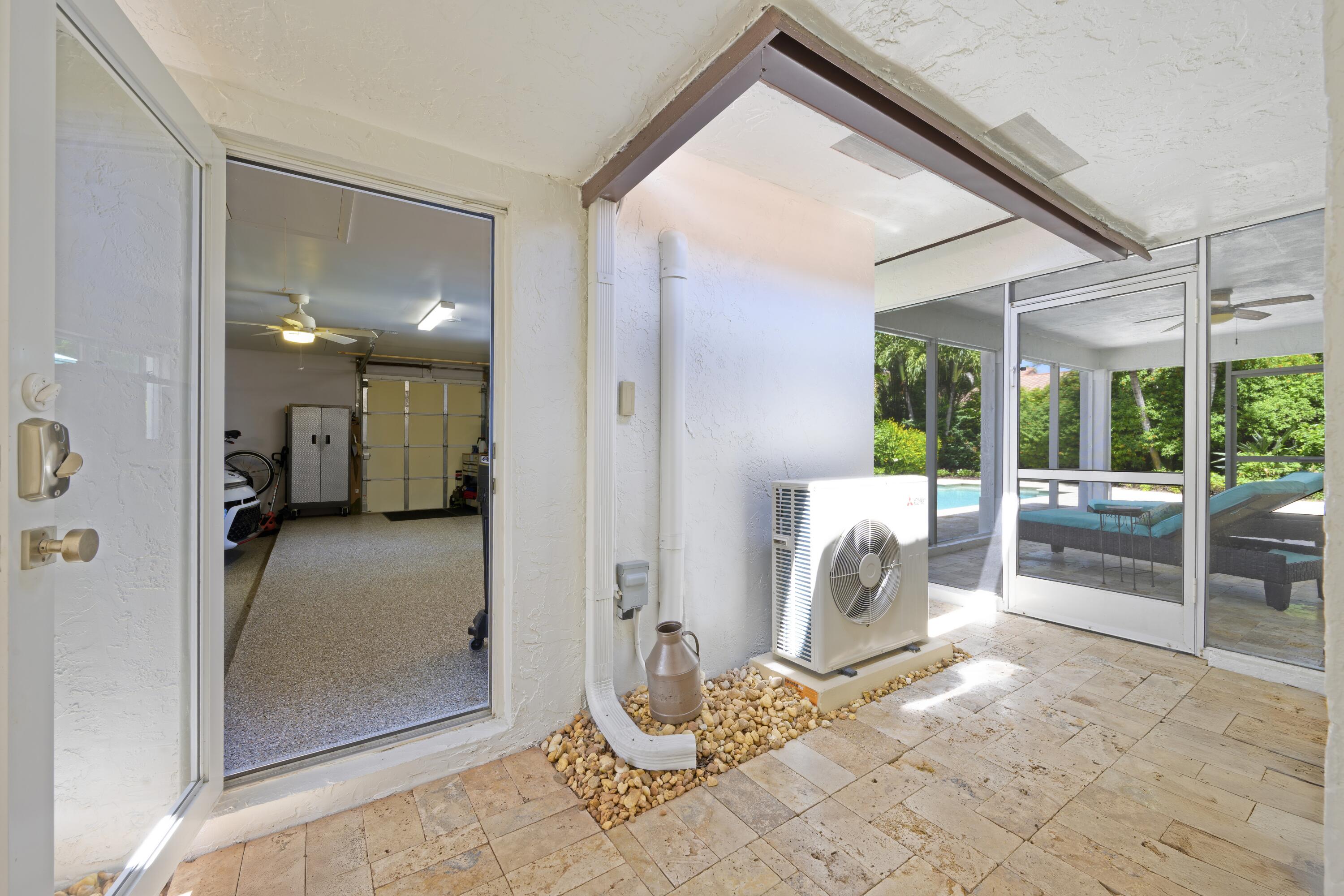 4535 Oak Tree Court Delray Beach, FL 33445 - Photo 31 of 43 a view of a livingroom with wooden floor and a glass door