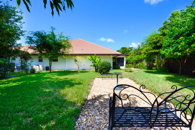 a view of a house with backyard and a patio