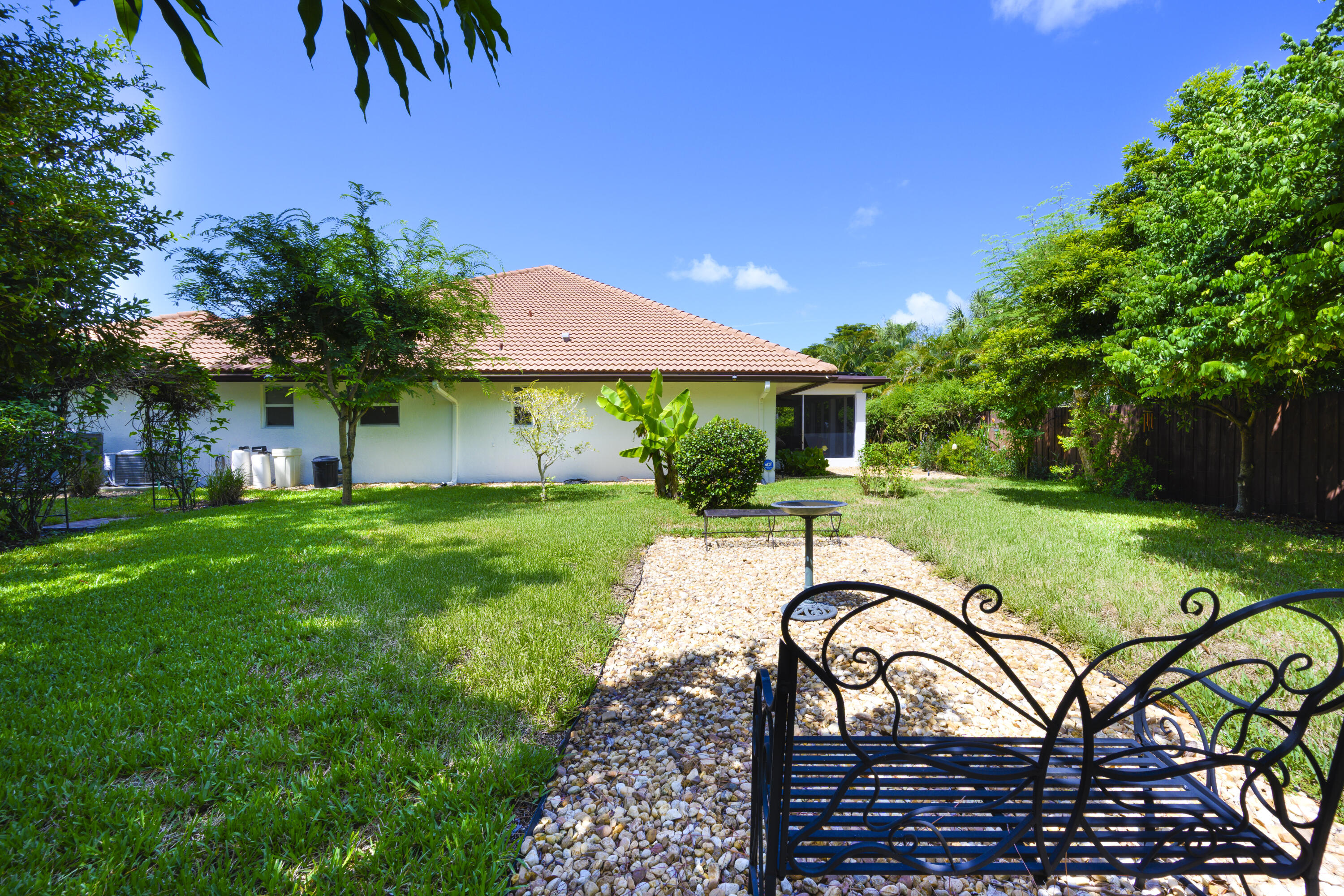 4535 Oak Tree Court Delray Beach, FL 33445 - Photo 33 of 43 a view of a house with backyard and a patio