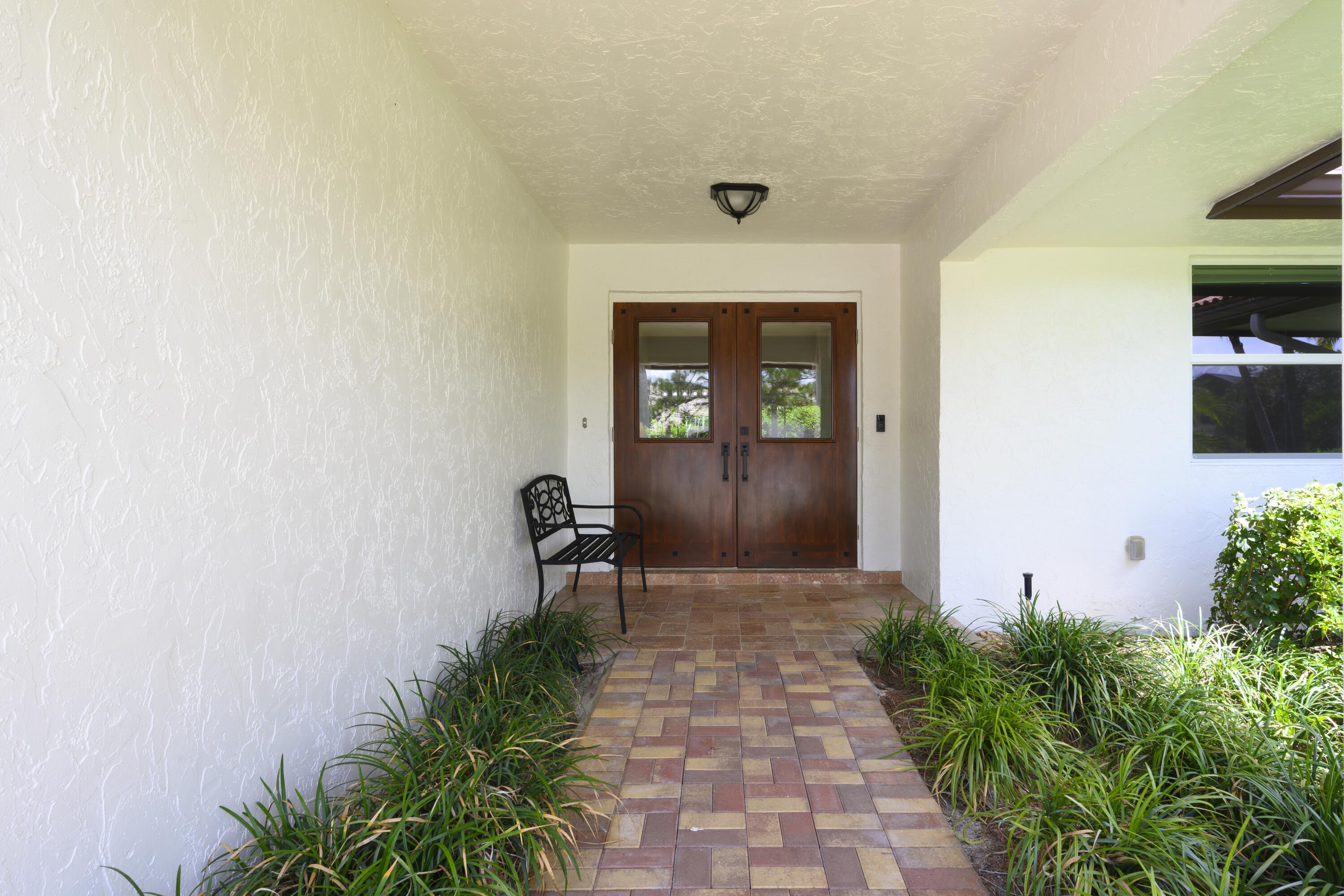 4535 Oak Tree Court Delray Beach, FL 33445 - Photo 36 of 43 a front view of a house with garden