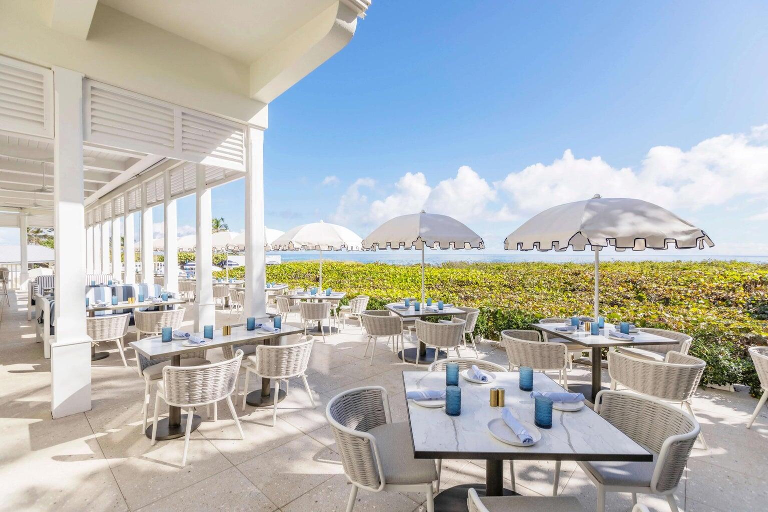 4535 Oak Tree Court Delray Beach, FL 33445 - Photo 41 of 43 a dining room with furniture and floor to ceiling windows