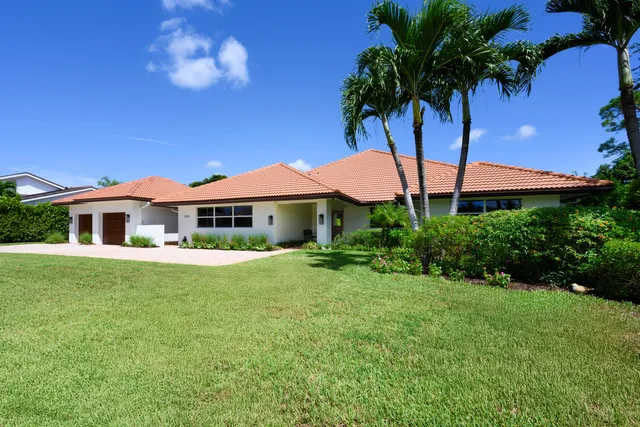 a front view of a house with a yard table and chairs