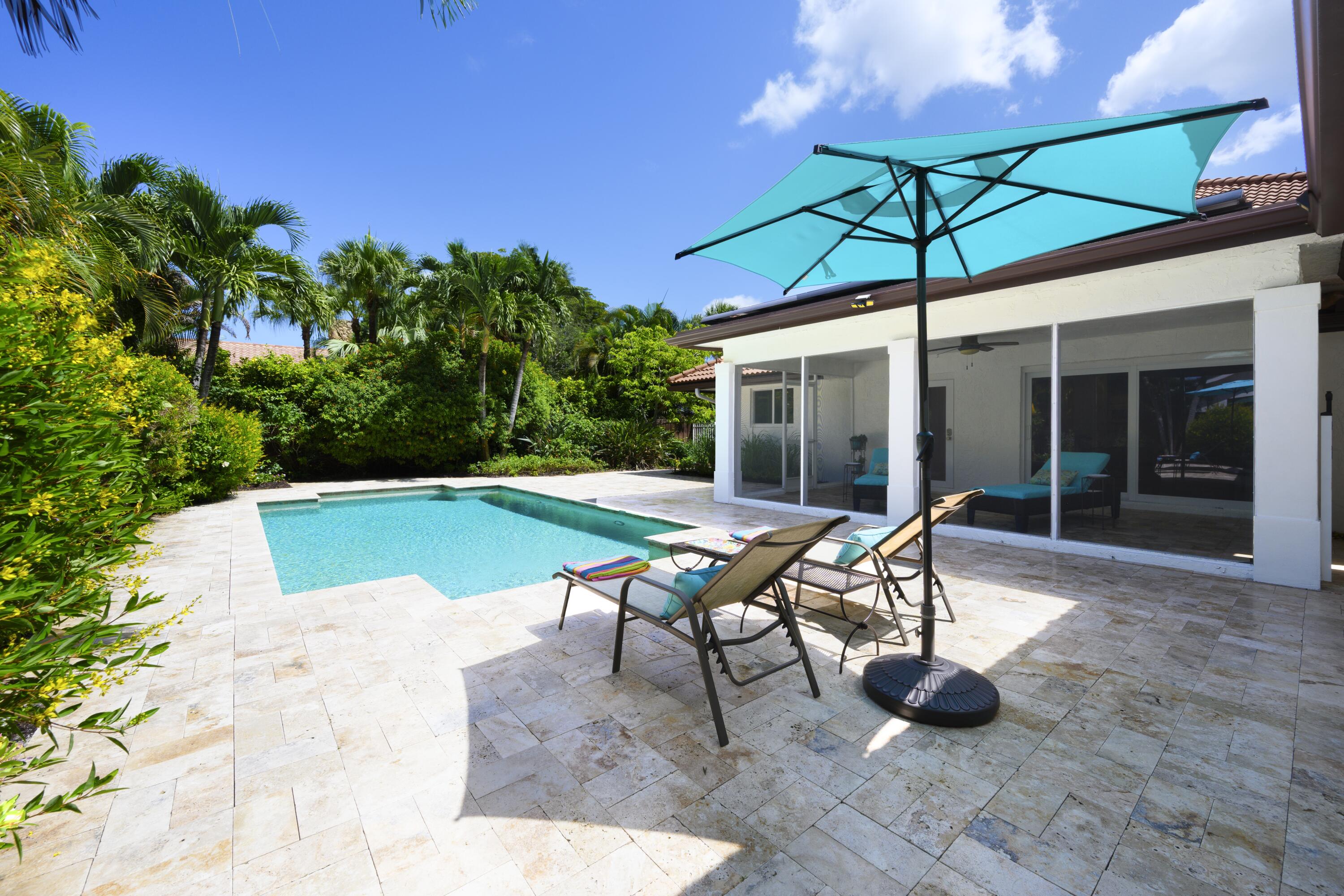 4535 Oak Tree Court Delray Beach, FL 33445 - Photo 7 of 43 a view of a swimming pool with a patio