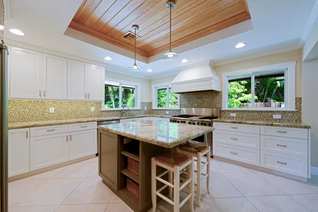 a kitchen with granite countertop cabinets stainless steel appliances and a counter space