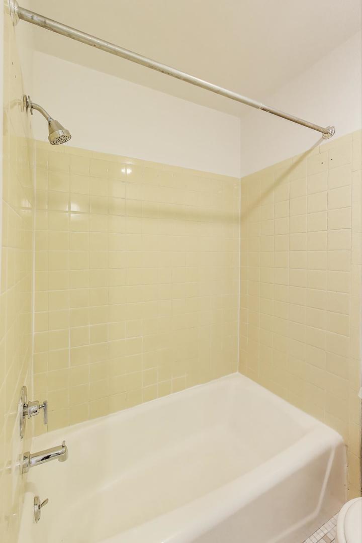 1906-1908 South Halsted Street, Unit 2R Chicago, IL 60608 - Photo 14 of 23 a bathroom with a shower and a bathtub