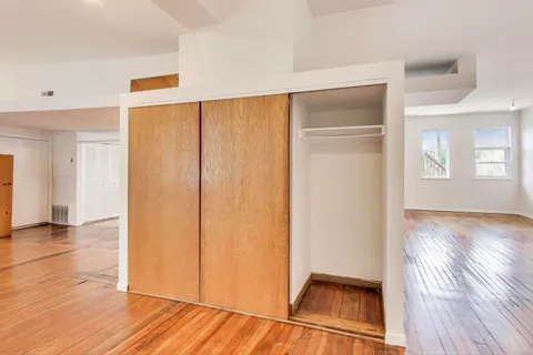 a view of a room with wooden floor