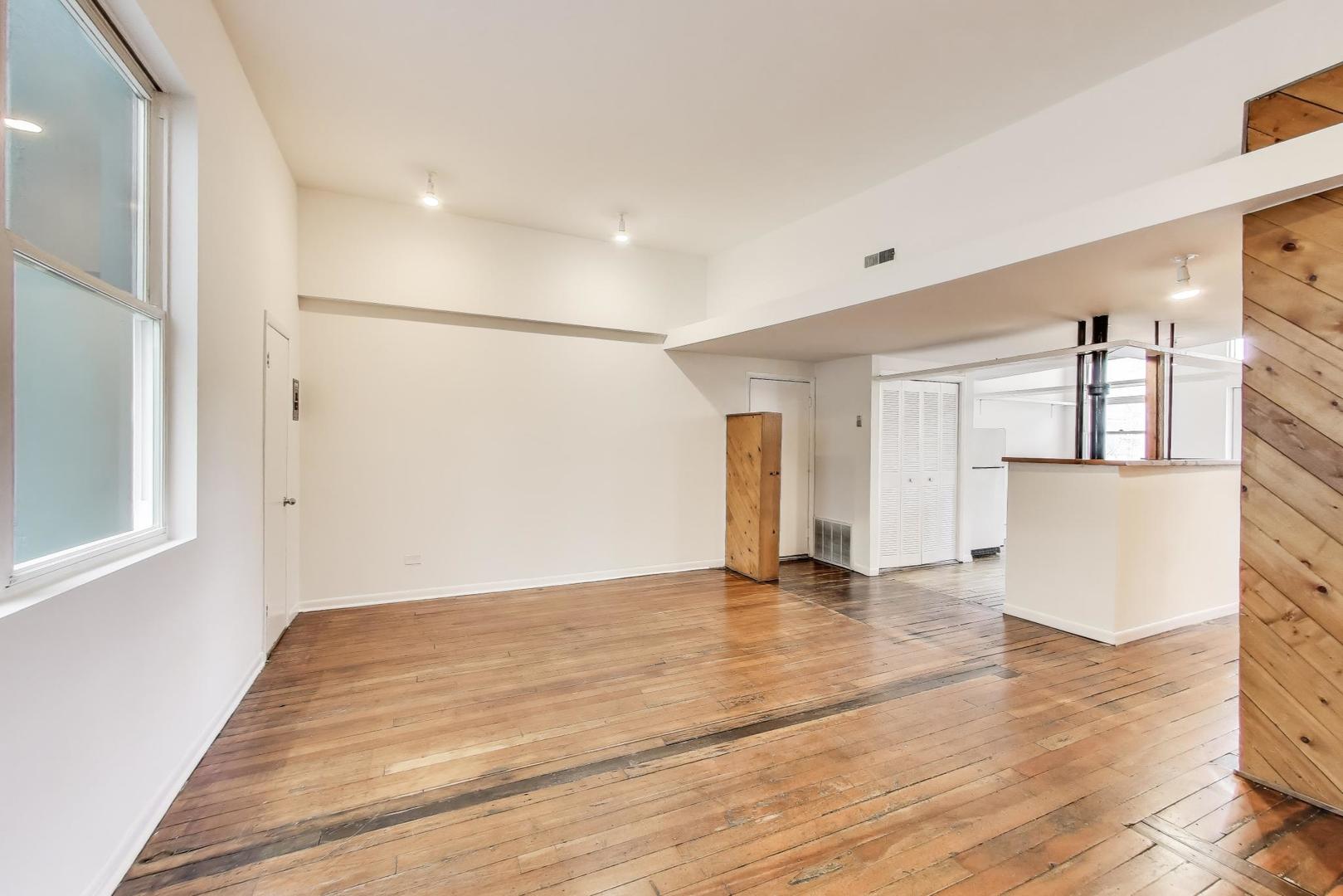 1906-1908 South Halsted Street, Unit 2R Chicago, IL 60608 - Photo 8 of 23 a view of an empty room with wooden floor and a window