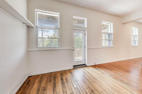 a kitchen with granite countertop a sink cabinets and wooden floor