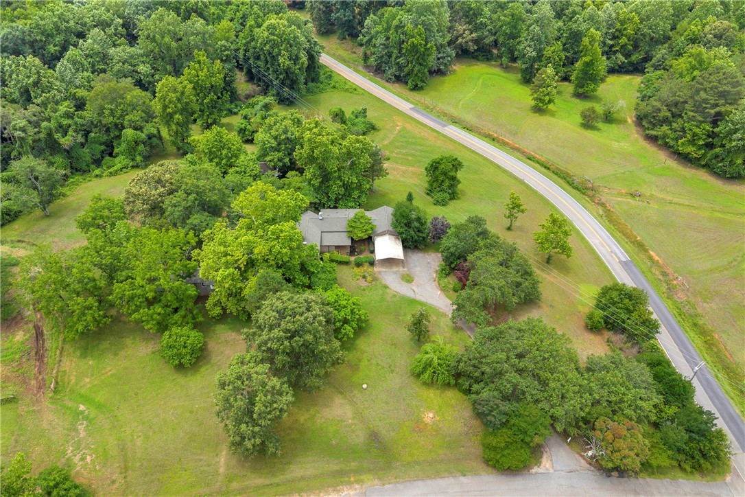 200 Chenault Road Townville, SC 29689 - Photo 37 of 47 An aerial perspective reveals a private residence nestled amidst lush green surroundings, with a winding road tracing its perimeter.