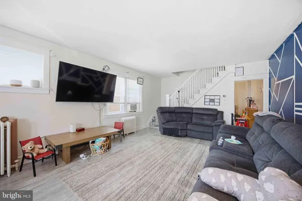 a living room with furniture and a flat screen tv