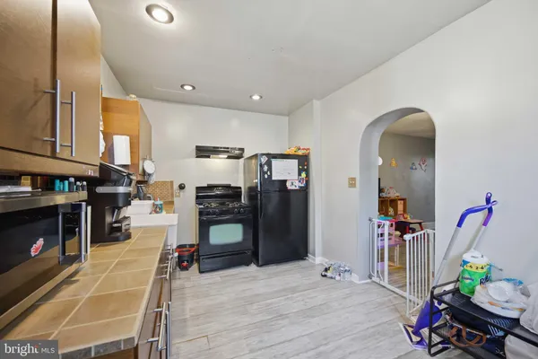 a living room with lots of furniture and kitchen view