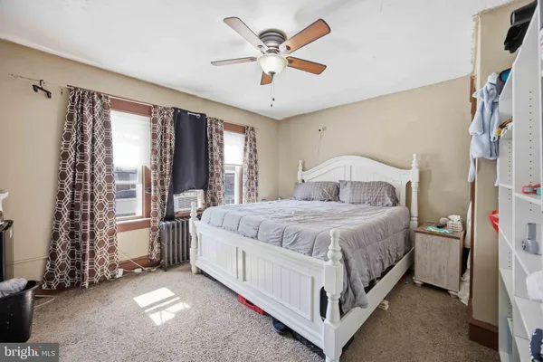 a spacious bedroom with a bed and a large window