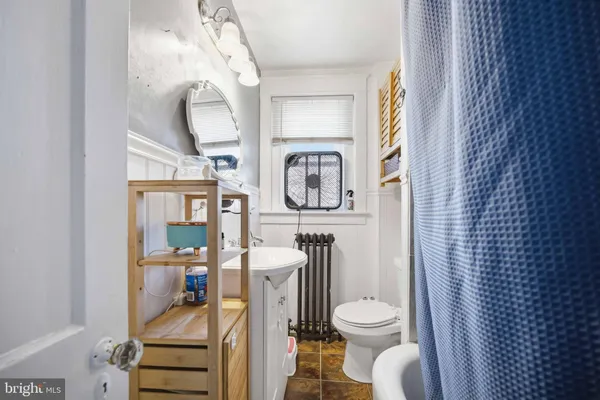 a white toilet sitting next to a bathroom sink