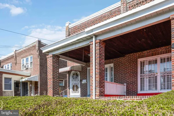 a view of a brick house with large windows