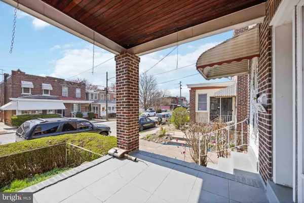 a view of a patio with couches chairs and a potted plant