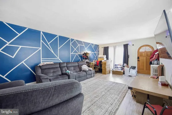 a living room with furniture and a mirror