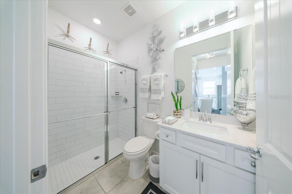 1833 Spring Shower Circle Kissimmee, FL 34744 - Photo 14 of 51 a bathroom with a sink a toilet and shower