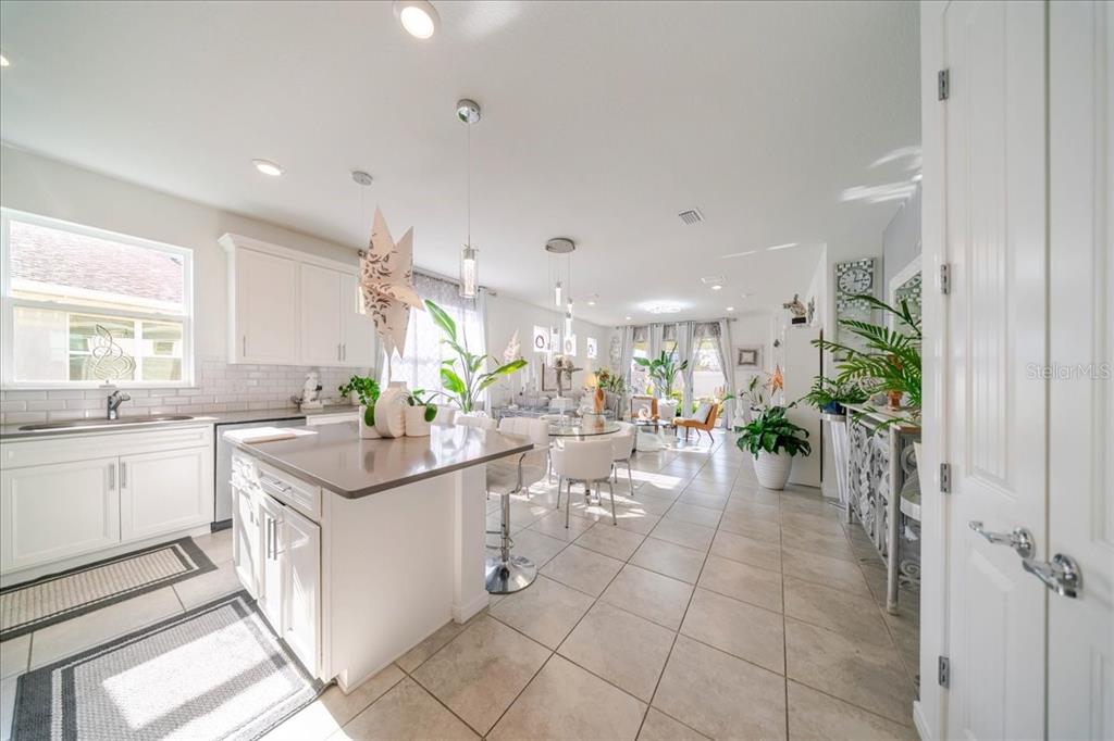 1833 Spring Shower Circle Kissimmee, FL 34744 - Photo 18 of 51 a room with lots of white furniture and potted plants