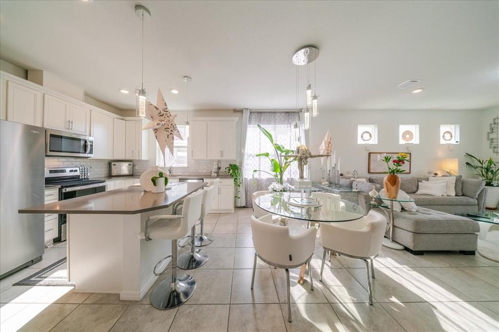 1833 Spring Shower Circle Kissimmee, FL 34744 - Photo 19 of 51 a kitchen with stainless steel appliances kitchen island granite countertop a sink and cabinets