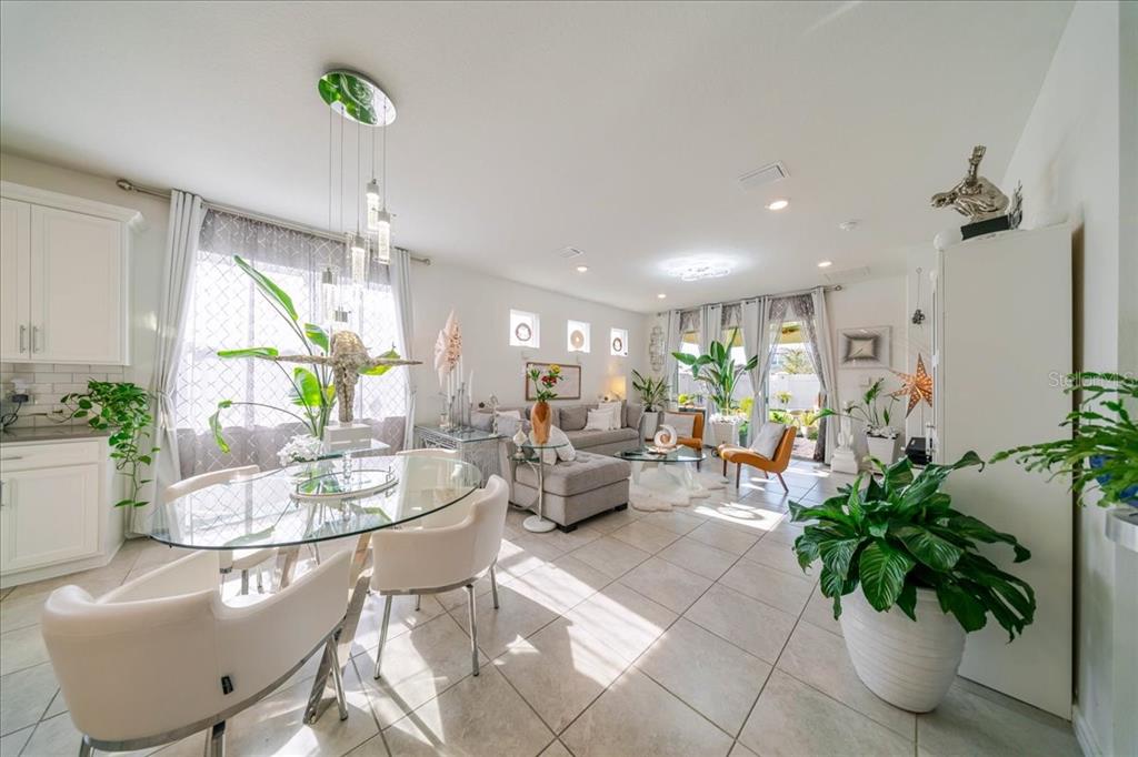 1833 Spring Shower Circle Kissimmee, FL 34744 - Photo 23 of 51 a living room with furniture potted plant and a chandelier