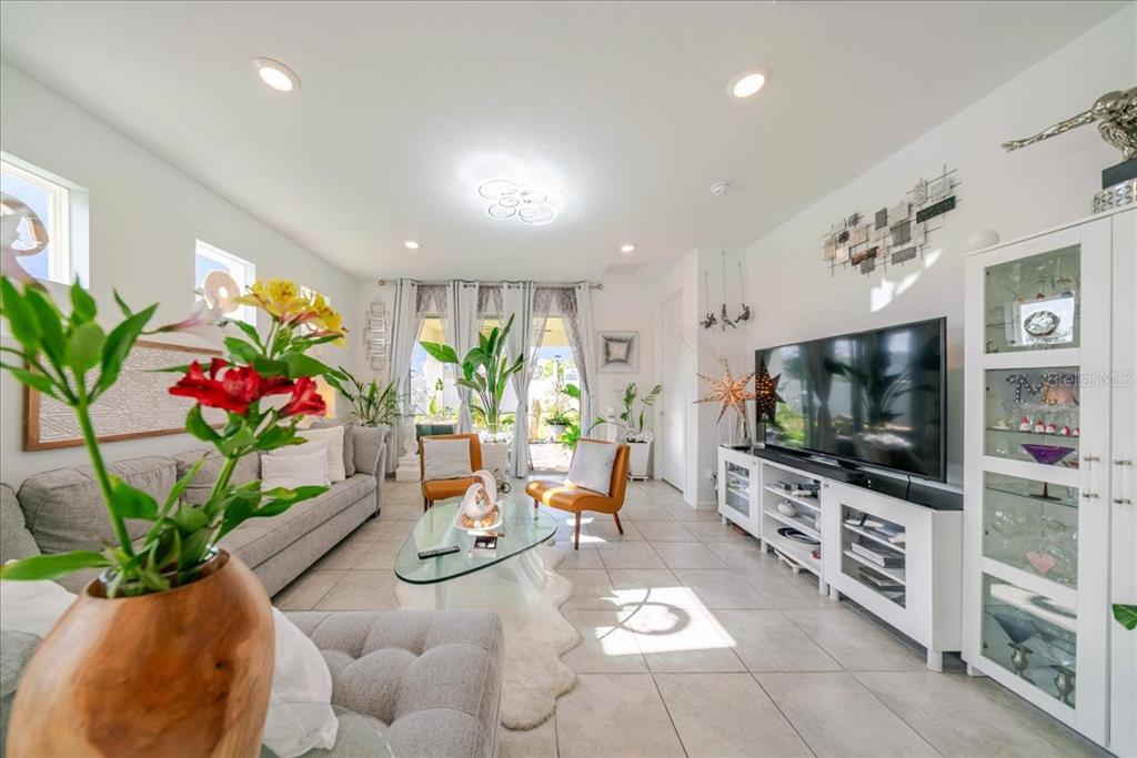 1833 Spring Shower Circle Kissimmee, FL 34744 - Photo 24 of 51 a living room with furniture and a flat screen tv