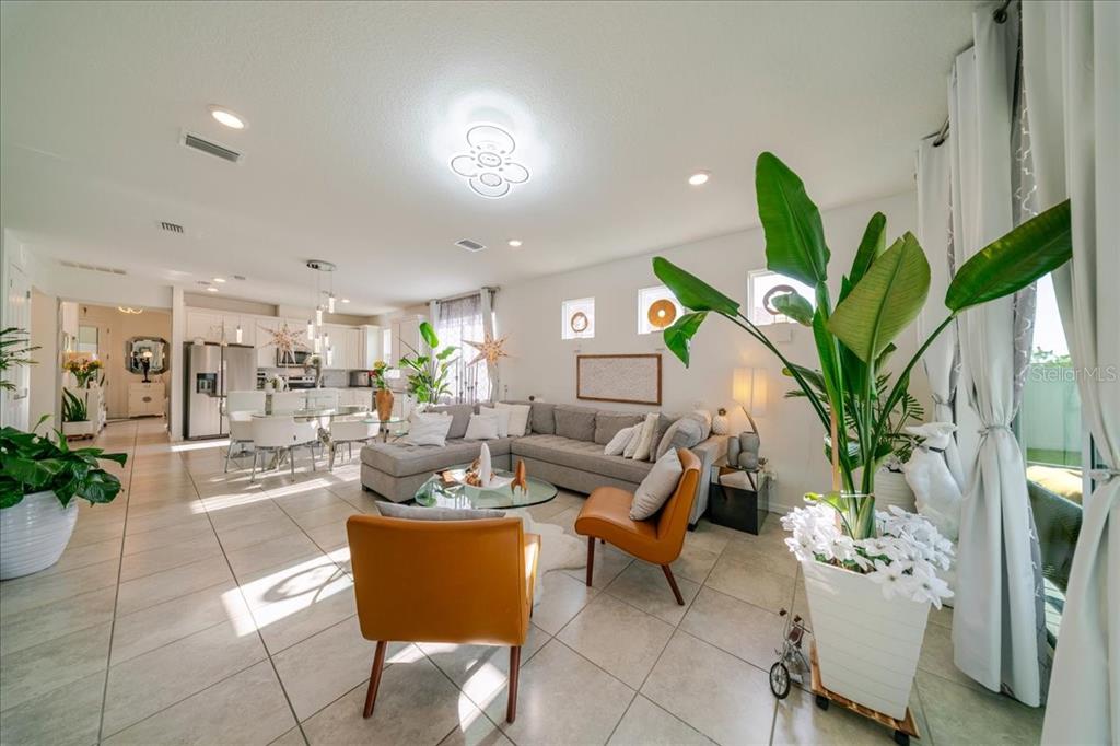 1833 Spring Shower Circle Kissimmee, FL 34744 - Photo 26 of 51 a living room with furniture a potted plant and a large window
