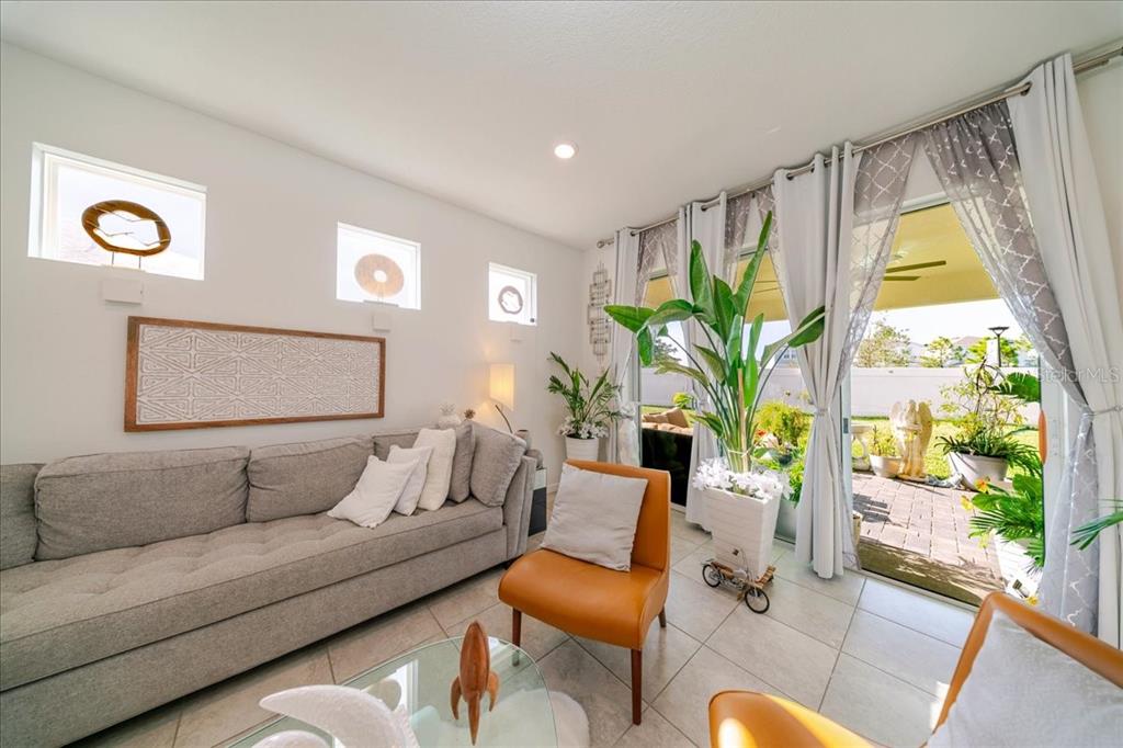 1833 Spring Shower Circle Kissimmee, FL 34744 - Photo 28 of 51 a living room with furniture and a large window