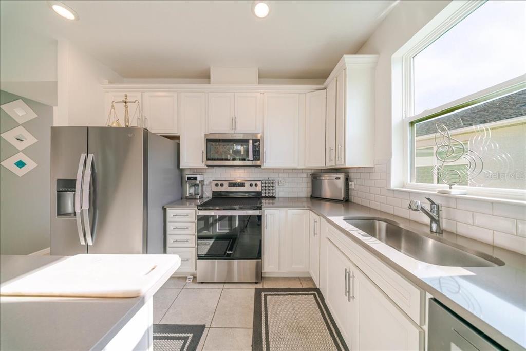 1833 Spring Shower Circle Kissimmee, FL 34744 - Photo 29 of 51 a kitchen with a sink stove and refrigerator