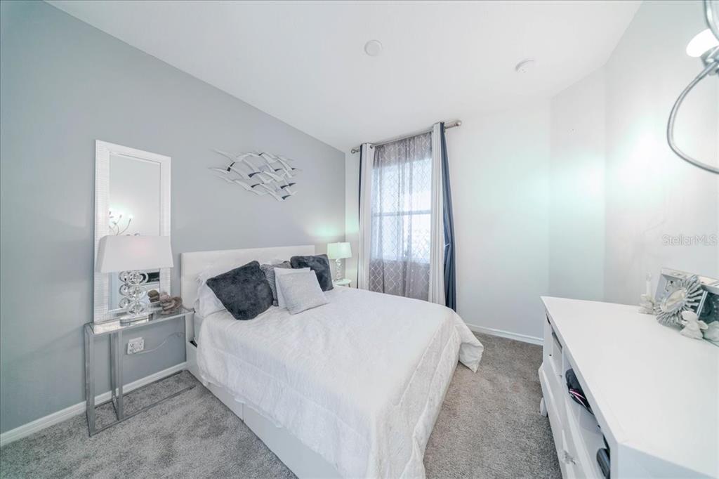 1833 Spring Shower Circle Kissimmee, FL 34744 - Photo 36 of 51 a bedroom with a bed and a table in it